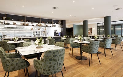 Elegant dining area with floral-patterned chairs