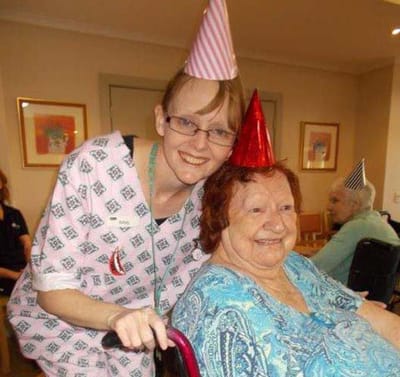 Staff member celebrating with resident at a party