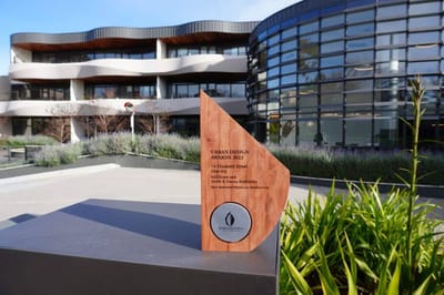 Award trophy in front of a modern building