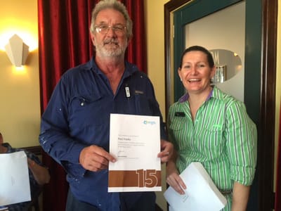 Staff member presenting a certificate to a resident