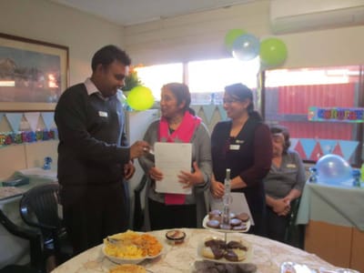 Staff engaging with a resident during a celebration