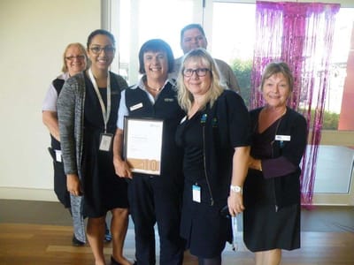 Staff members celebrating with an award