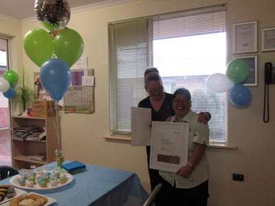 Staff celebrating with a resident at the facility