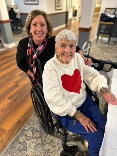 Staff member assisting a resident in a common area
