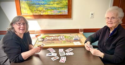 Two residents enjoying a card game in a common area