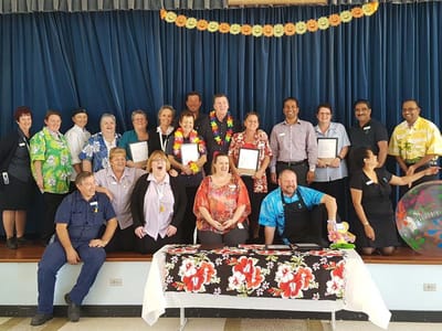 Staff and residents posing during a celebration