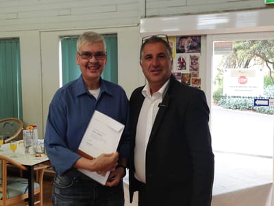 Two individuals celebrating an achievement in a common area