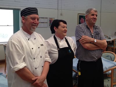 Staff members smiling in a dining area