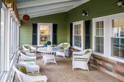Outdoor seating area with wicker chairs and tables