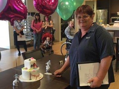 Celebration with a cake and balloons in a common area