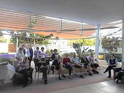 Residents and staff gathered in a welcoming activity area