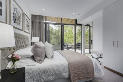Stylish bedroom with a view of greenery outside