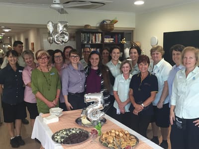 Group photo of staff celebrating a milestone event