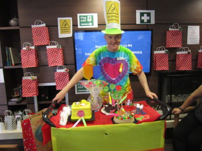 Staff member leading a trivia activity with decorations