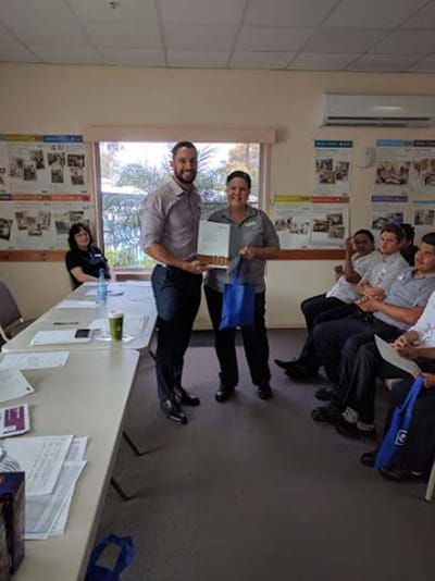 Staff member receiving an award in a common area