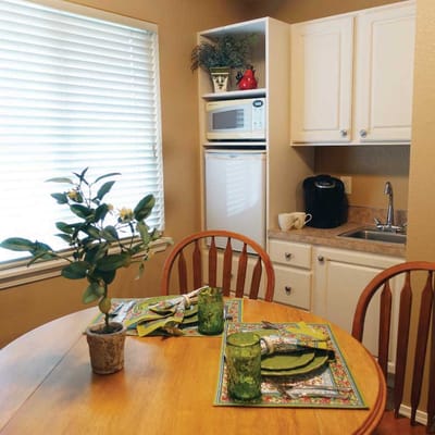 Cozy kitchen area with dining table and green decor