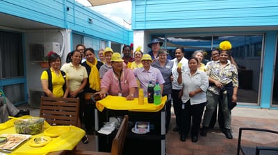 Group of staff celebrating outdoors at the facility