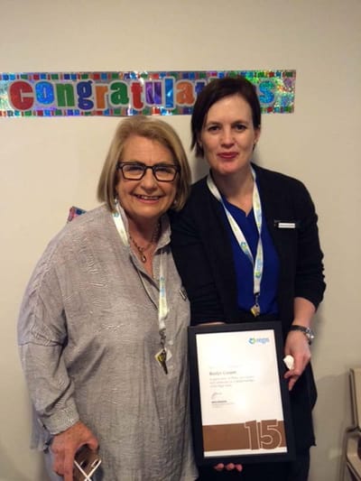 Staff member presenting certificate to a resident