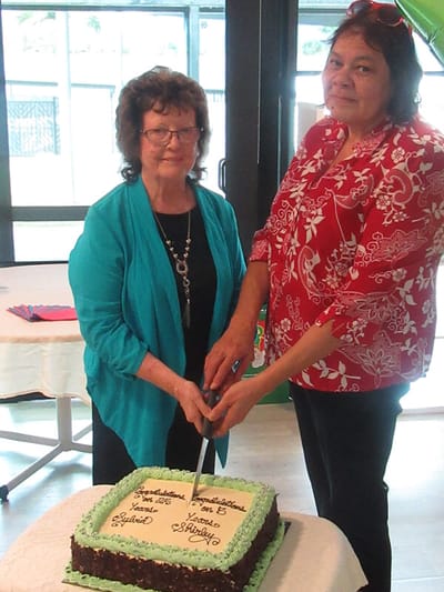 Two residents celebrating with a cake