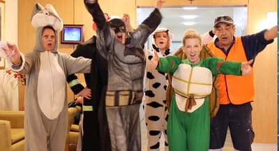 Staff and residents in costumes celebrating an event
