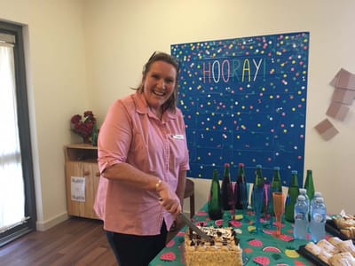 Staff member celebrating with a cake