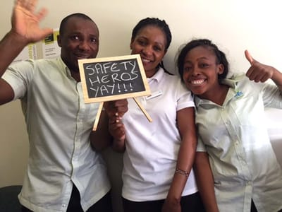 Staff celebrating safety with a sign