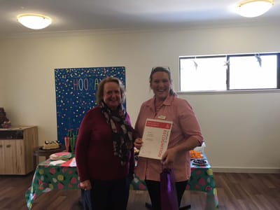 Two women celebrating recognition in a decorated common area