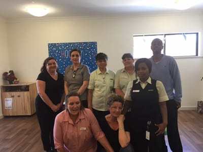 Staff members posing in a common area