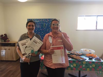 Staff celebrating with recognition awards and treats