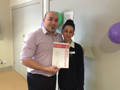 Staff members posing for a recognition award photo