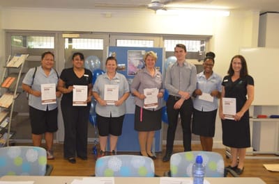 Staff members celebrating awards in a facility common area