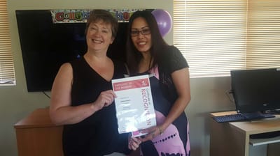 Staff member receiving an employee recognition award