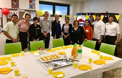 Staff and residents gathered for an event in a common area