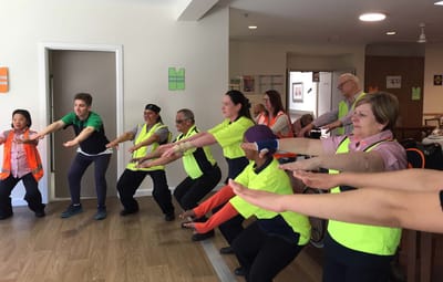 Residents and staff participating in a group exercise activity