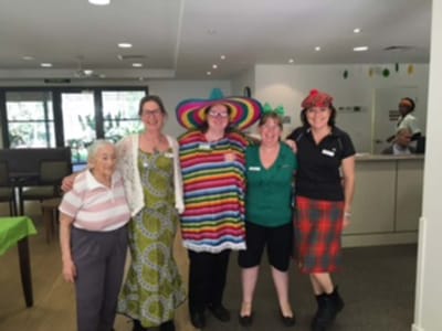 Staff members dressed in fun attire during a celebration