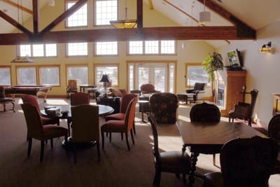 Common area lounge with comfy furniture and large windows