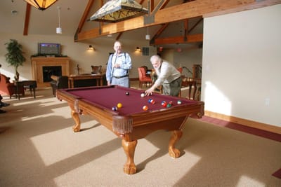 Residents playing billiards in a lounge area