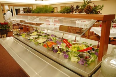 Salad bar with fresh vegetables in the dining area