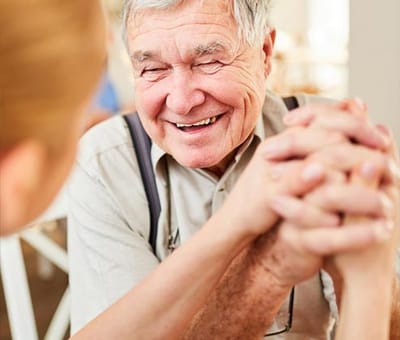 Senior resident smiling while engaged in an activity