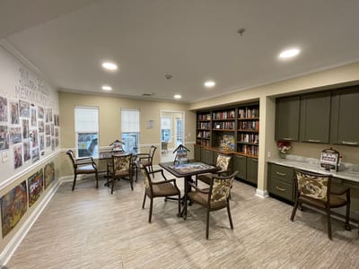 Bright common area with tables and bookshelves