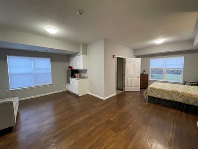 Private resident room with bed and kitchenette