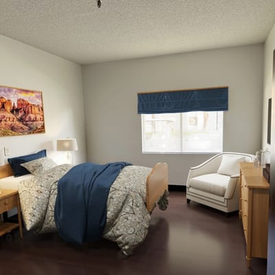 Cozy resident bedroom with bed and chair.
