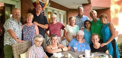 Residents and staff celebrating outdoors together.