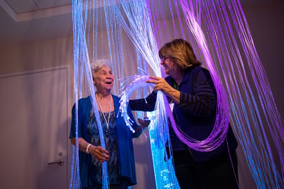Residents enjoying an interactive activity with lights.