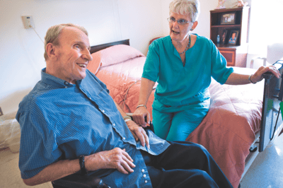 Resident and nurse interacting in a room