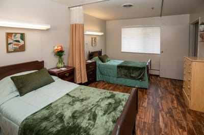 Comfortable shared resident room with two beds.