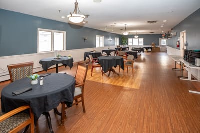 Dining area with tables and chairs set up.