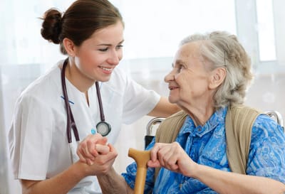 Health worker interacting with an elderly woman