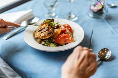 A beautifully plated meal being enjoyed by a resident.