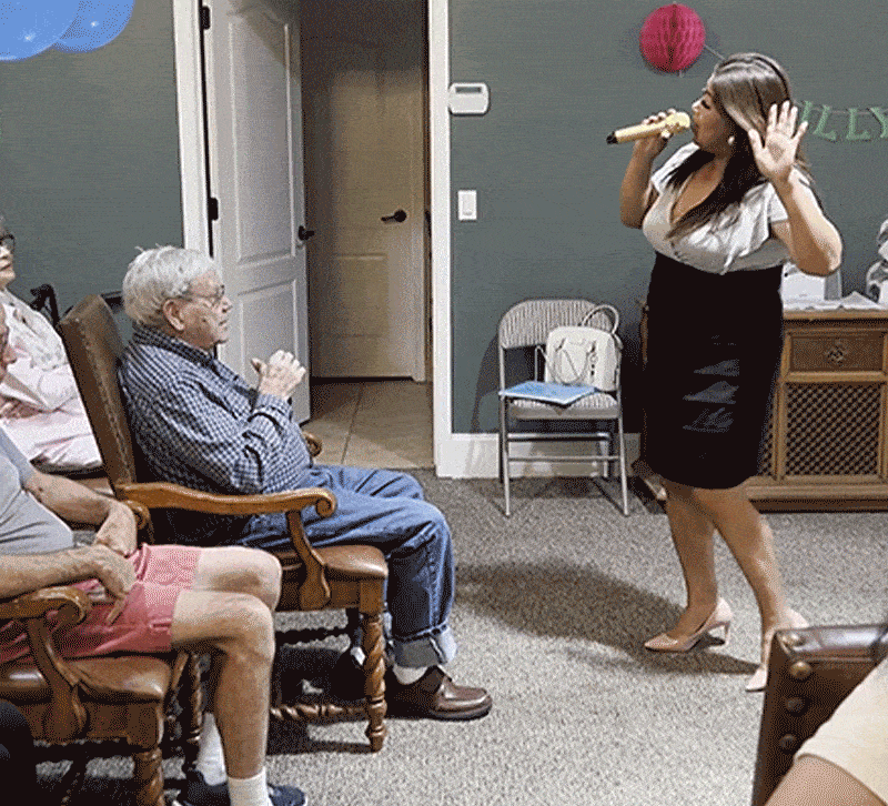 Resident enjoys a performance in a communal space.
